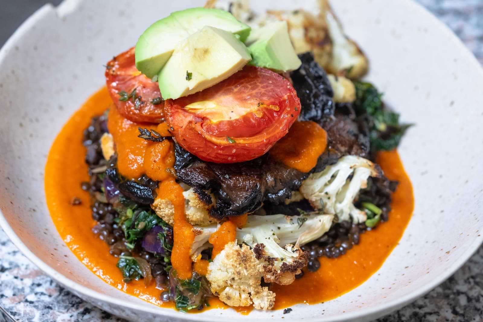 Braised short rib over lentils with roasted cauliflower and red pepper coulis